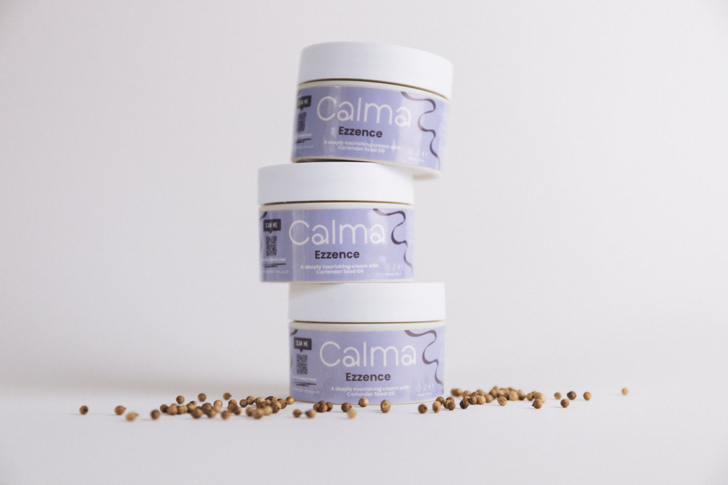 Three Calma Ezzence containers with a small amount of seeds on a white background