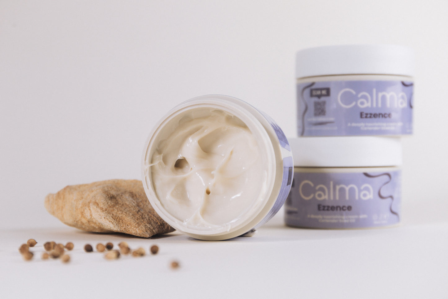 Two jars of Calma Essence cream on a white background